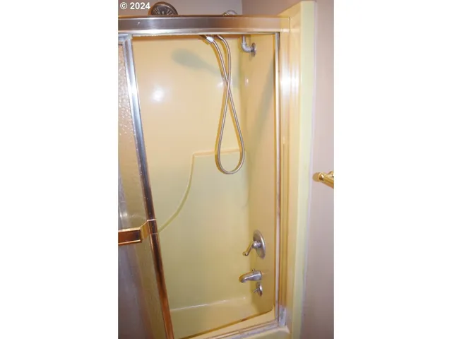 a bathroom with a glass shower door