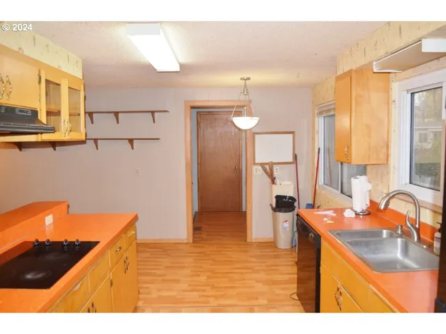 a kitchen with stainless steel appliances granite countertop a sink and a refrigerator