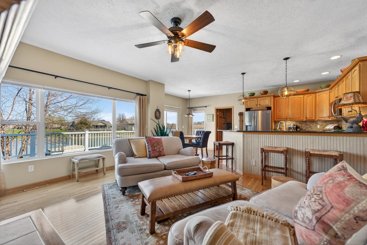 12805 Edgewater Pointe Winnebago, IL 61088 - Photo 11 of 47 a living room with furniture and a large window with kitchen view