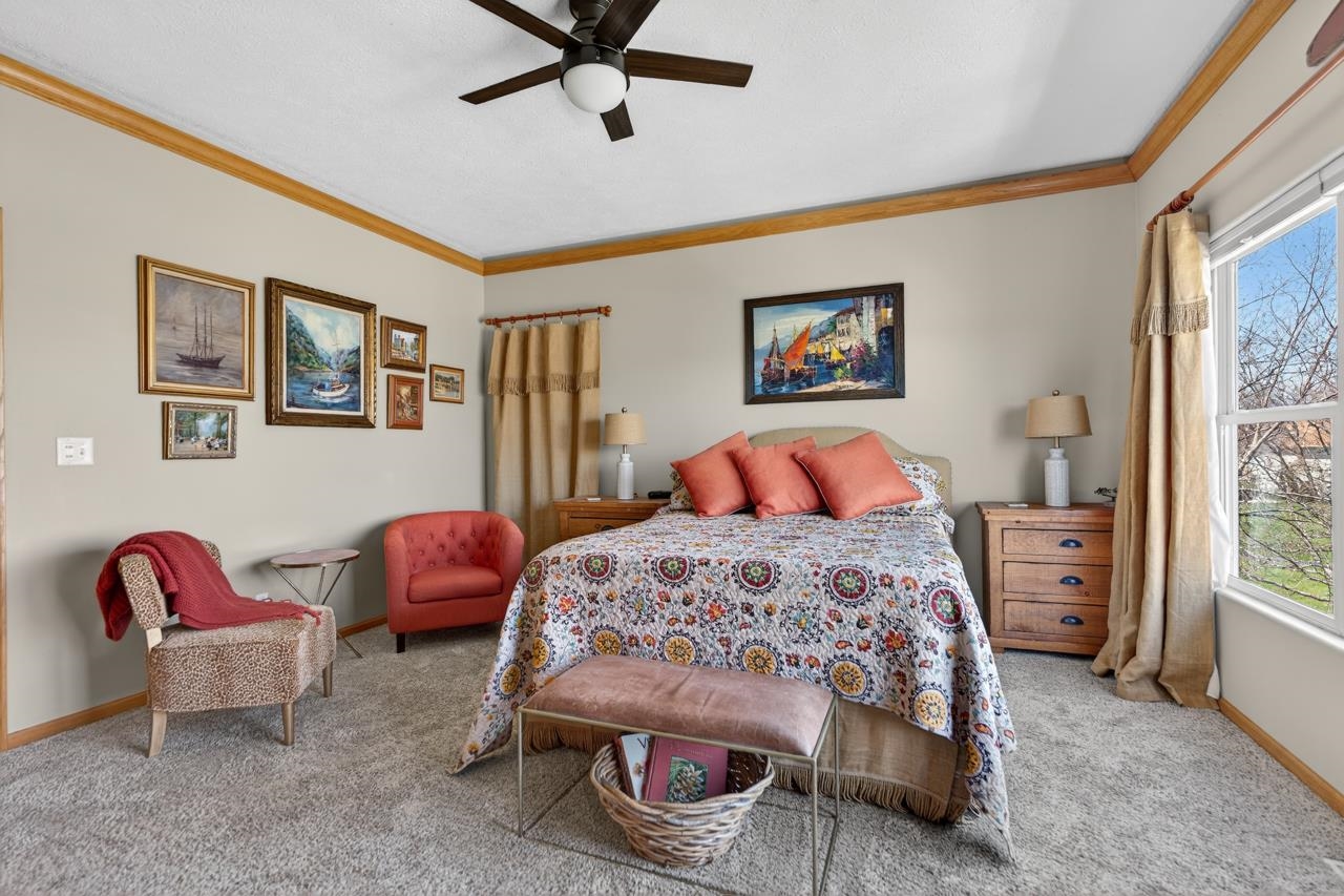 12805 Edgewater Pointe Winnebago, IL 61088 - Photo 19 of 47 a bedroom with a bed and a chandelier