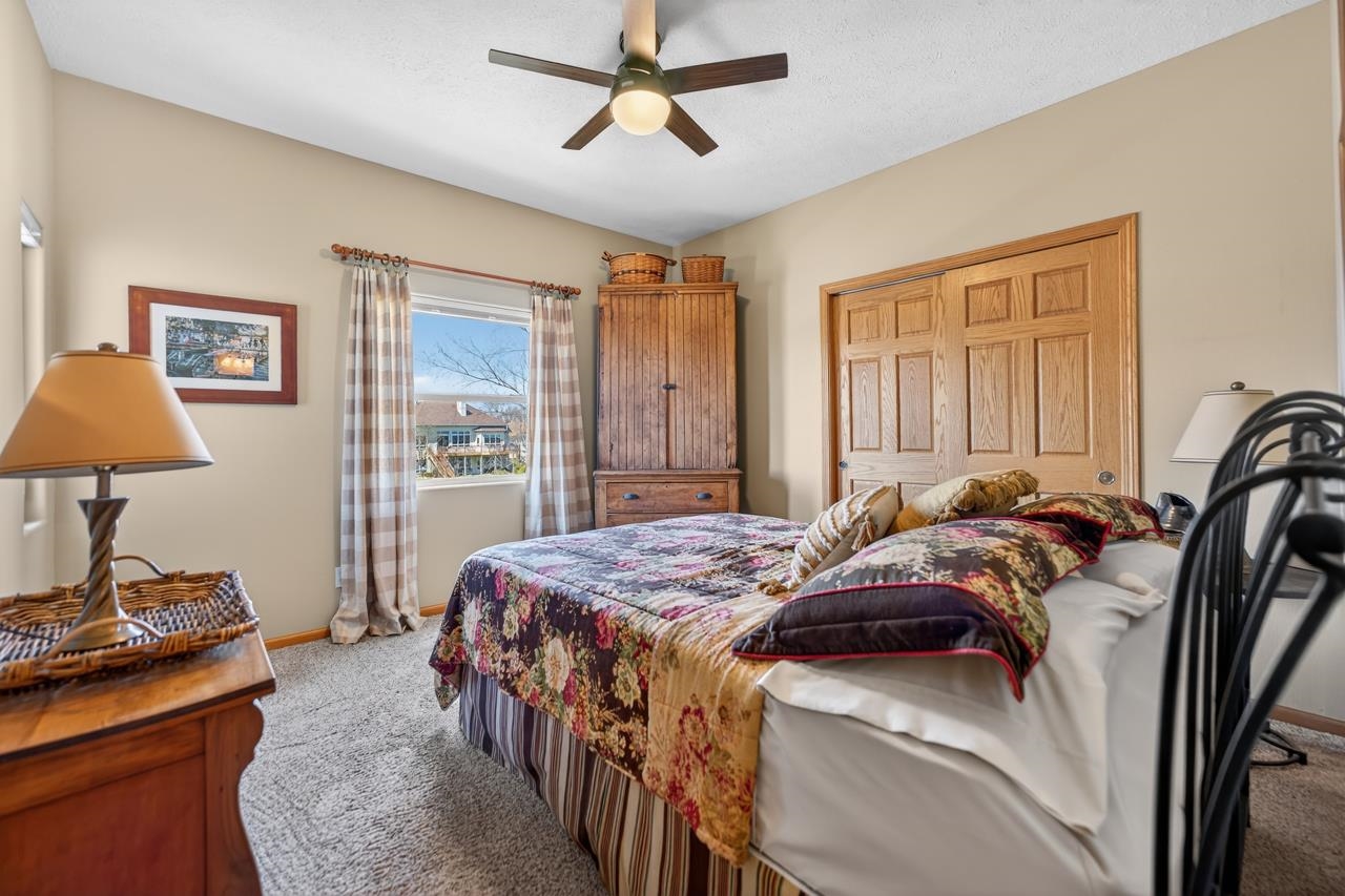 12805 Edgewater Pointe Winnebago, IL 61088 - Photo 24 of 47 a bedroom with a bed and a lamp