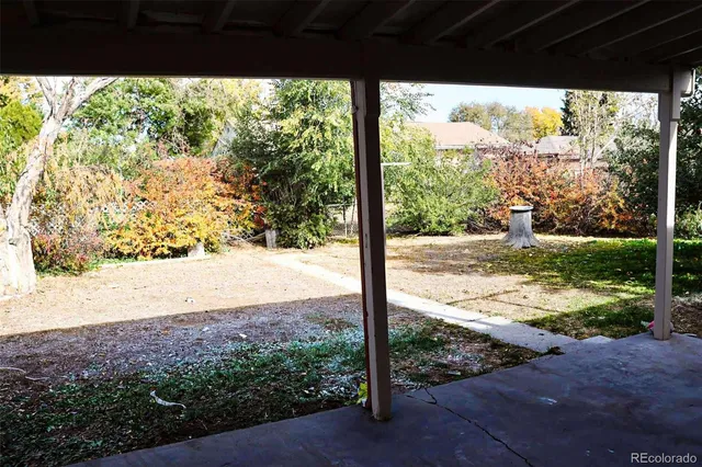 a view of a yard with wooden fence