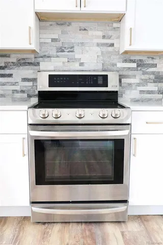 a stove top oven sitting inside of a kitchen