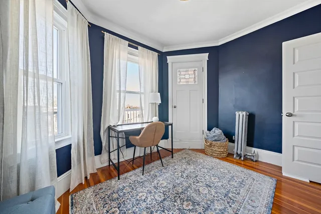 a living room with furniture rug and wooden floor