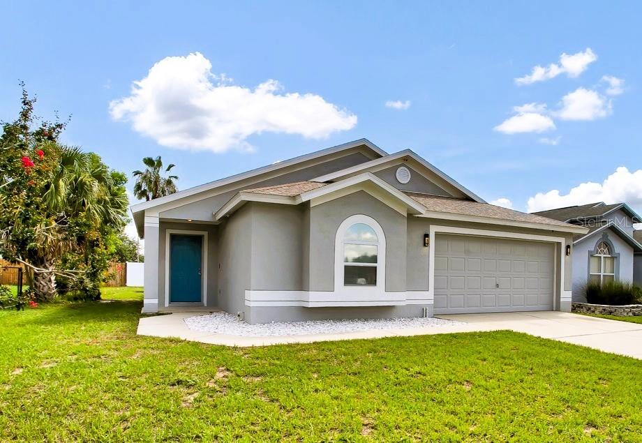 1706 Erin Brooke Drive Valrico, FL 33594 - Photo 1 of 39 a front view of a house with a yard and garage