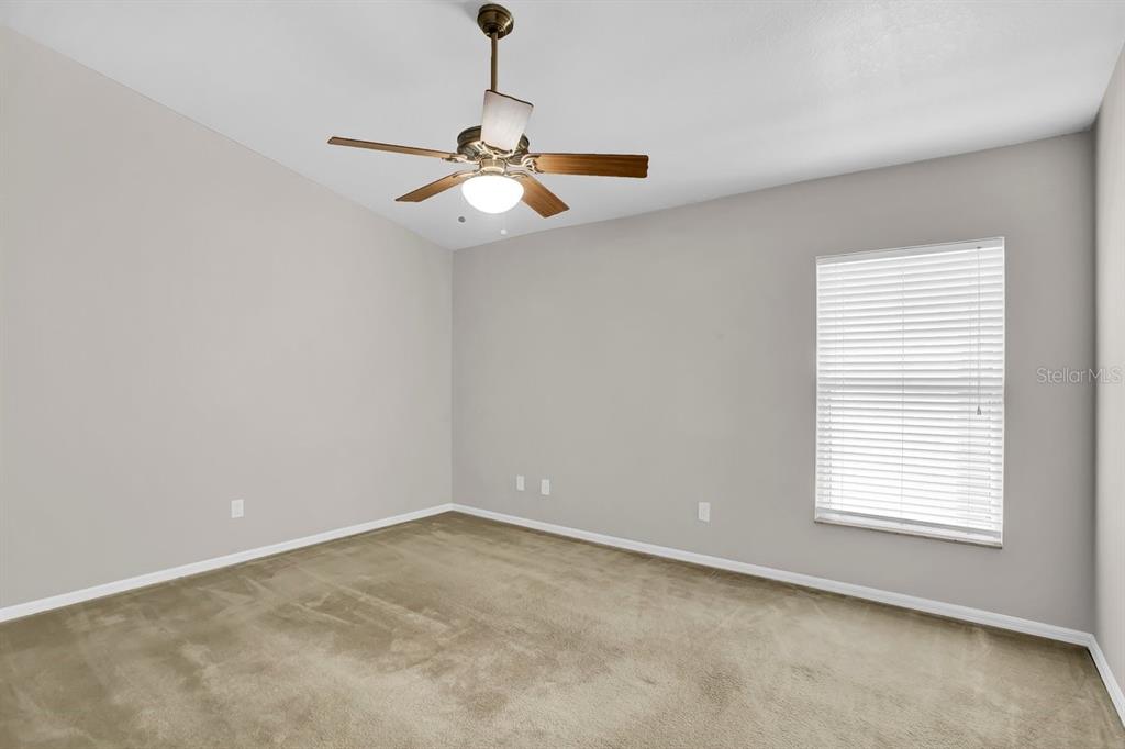 1706 Erin Brooke Drive Valrico, FL 33594 - Photo 12 of 39 an empty room with windows and fan