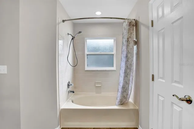 a bathroom with a tub and shower