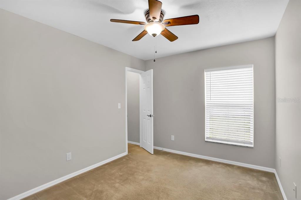 1706 Erin Brooke Drive Valrico, FL 33594 - Photo 21 of 39 an empty room with windows and fan