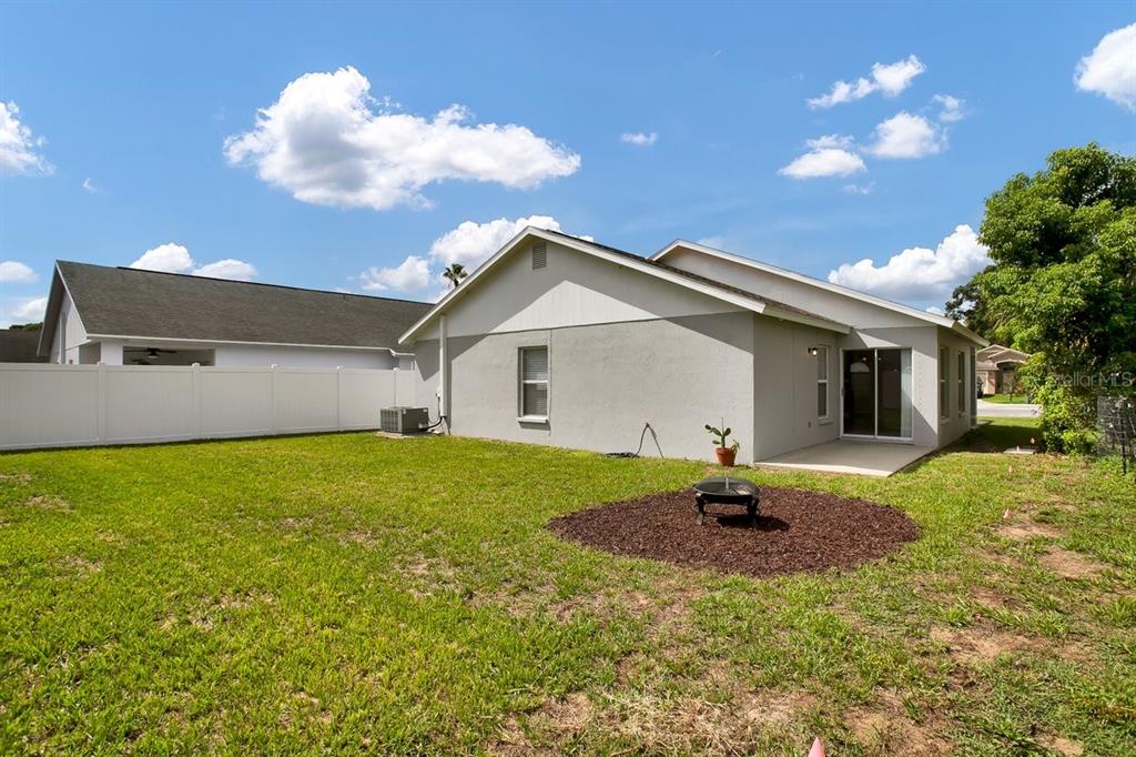1706 Erin Brooke Drive Valrico, FL 33594 - Photo 25 of 39 a front view of house with yard and trees in the background