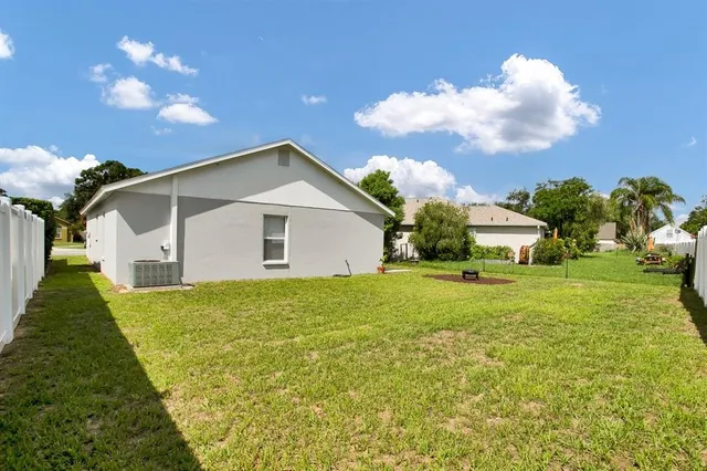 a front view of house with yard and trees