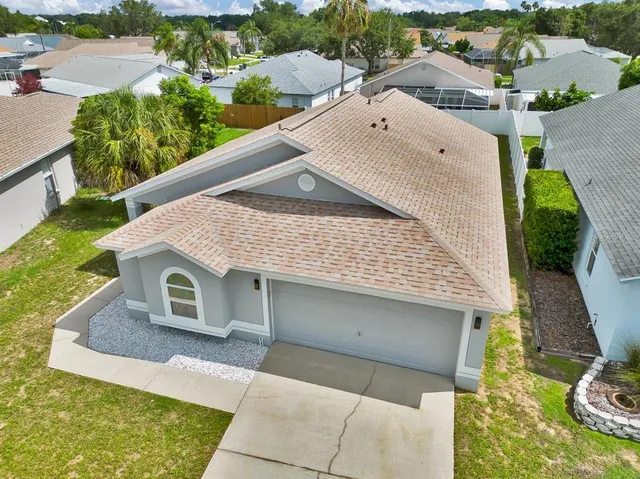 an aerial view of a house with swimming pool and ocean view