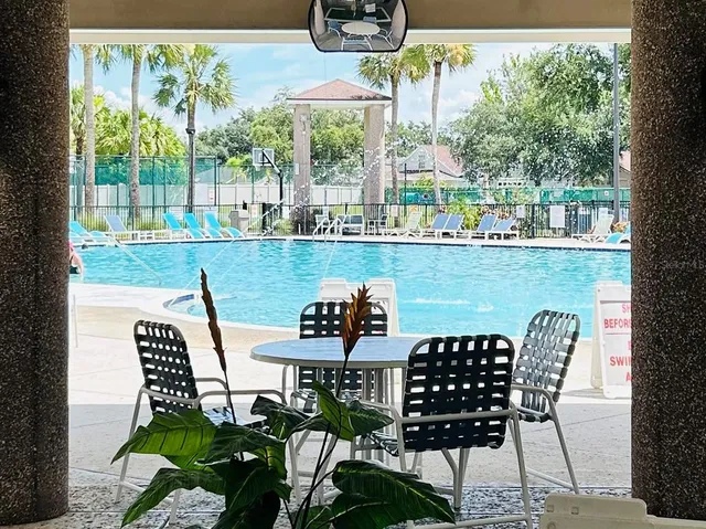 a view of a chairs and table in patio with a yard
