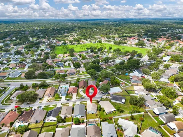 an aerial view of residential houses with outdoor space and swimming pool
