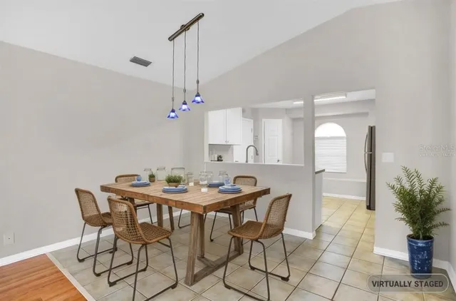 a dining room with a table and chairs