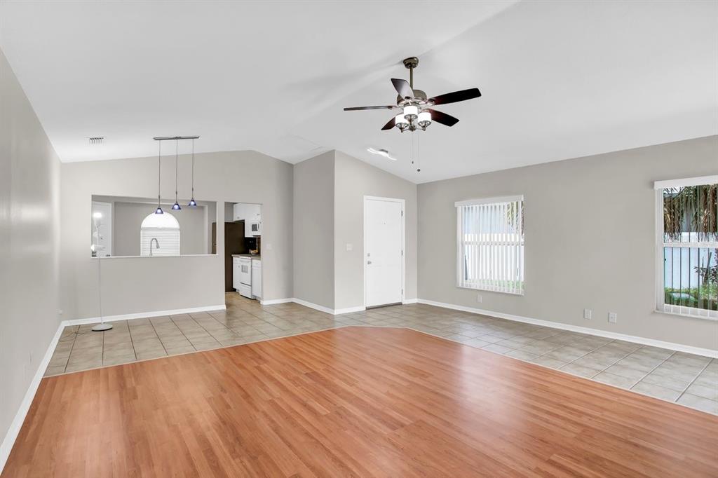 1706 Erin Brooke Drive Valrico, FL 33594 - Photo 6 of 39 a view of an empty room with window and wooden floor