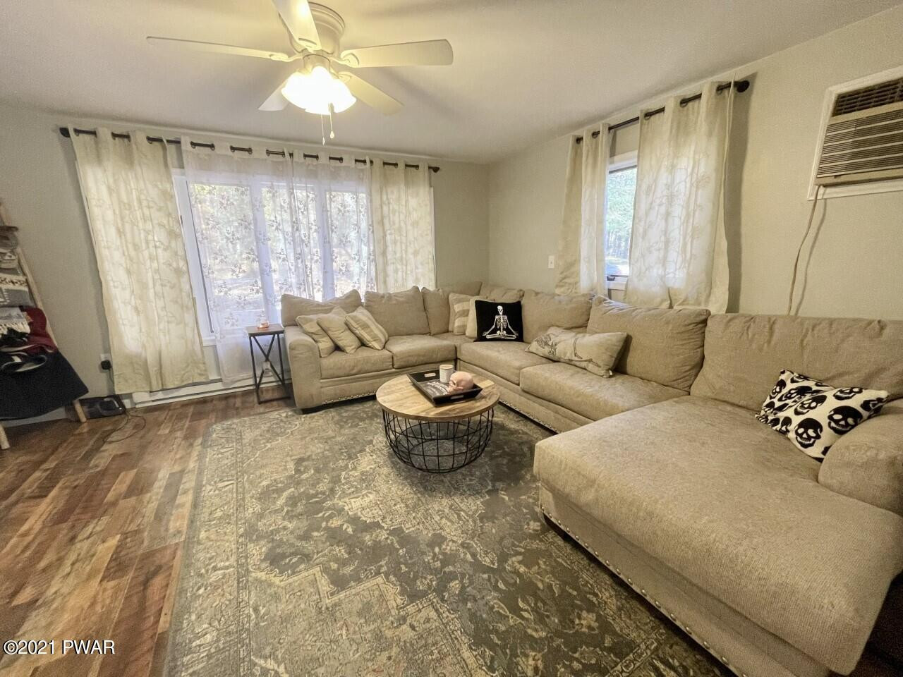 149 Walker Lake Road Shohola, PA 18458 - Photo 8 of 51 a living room with furniture and a large window
