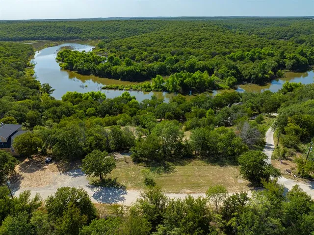 an aerial view of a houses with a yard
