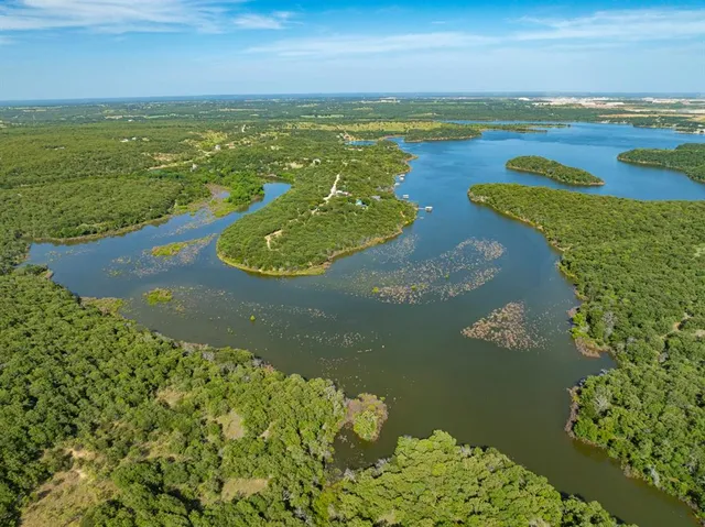 an aerial view of a houses with yard