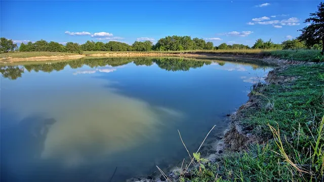 an aerial view of a house with a lake view