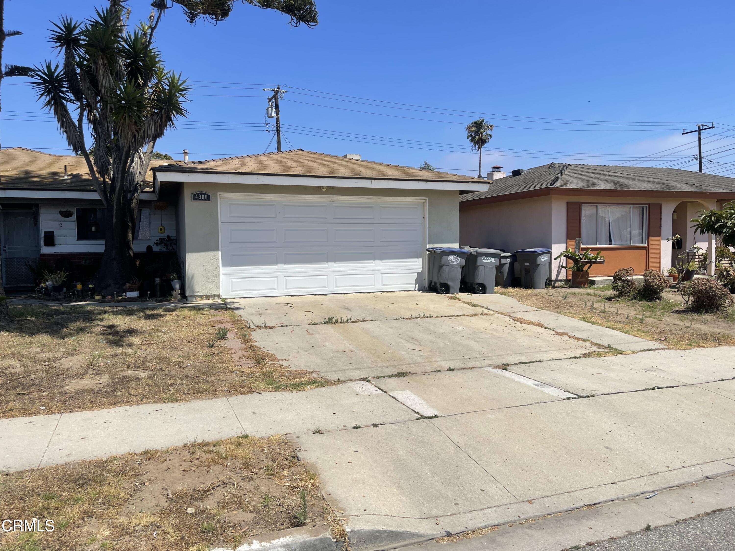 4900 Reeder Avenue Oxnard, CA 93033 - Photo 3 of 13 a front view of a house with a yard