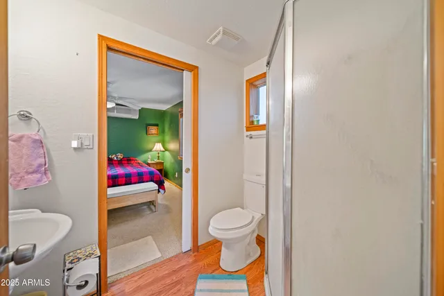 a en suite bathroom with a shower sink and a mirror