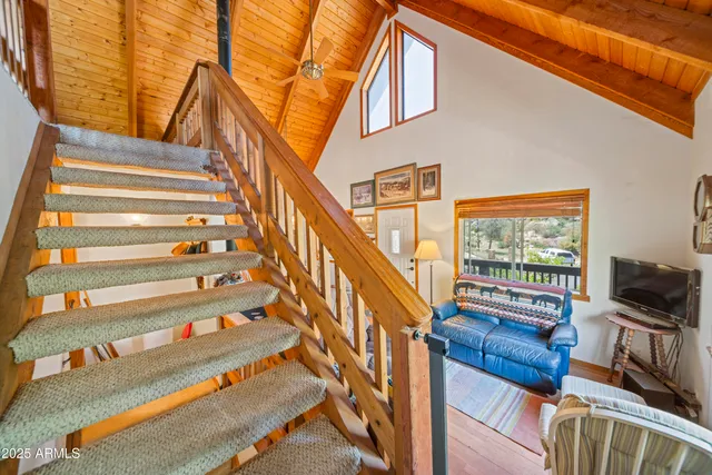 a living room with furniture a flat screen tv and a window