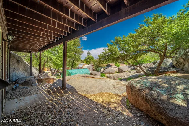 a view of balcony with wooden floor and fence