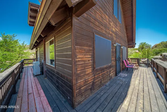 a balcony with furniture and wooden floor