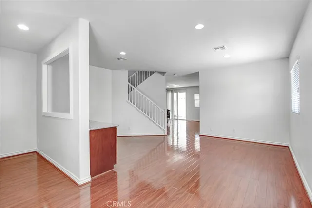a kitchen with granite countertop a sink a counter space appliances and cabinets