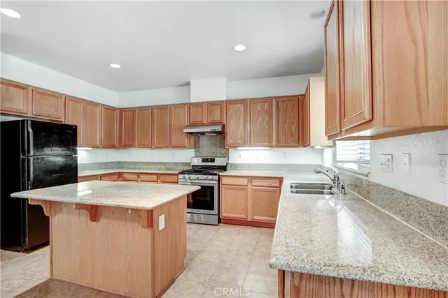 a view of empty room with wooden floor and fireplace