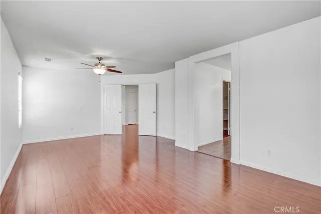 a spacious bathroom with a granite countertop sink a mirror a bathtub and shower