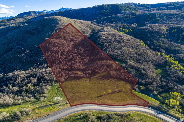 4549 East Osprey Ranch Drive, Unit 23 Eden, UT 84310 - Photo 1 of 19 Aerial view of property and surrounding area with property boundaries highlighted and a mountainous background