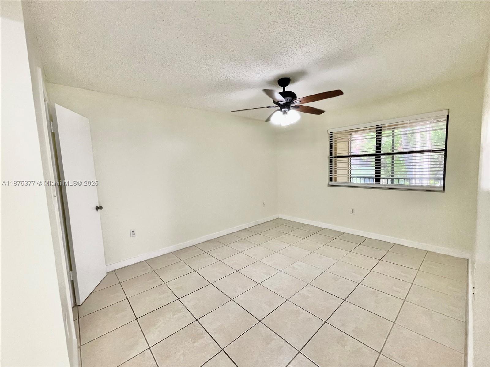15591 Southwest 105th Terrace, Unit 527 Miami, FL 33196 - Photo 16 of 24 wooden floor in an empty room with a window