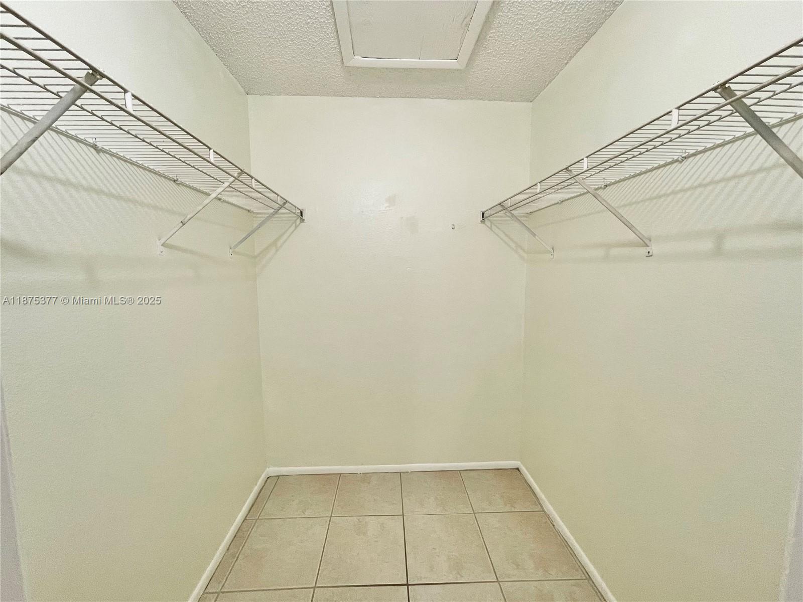 15591 Southwest 105th Terrace, Unit 527 Miami, FL 33196 - Photo 17 of 24 a view of a room with racks on the wall