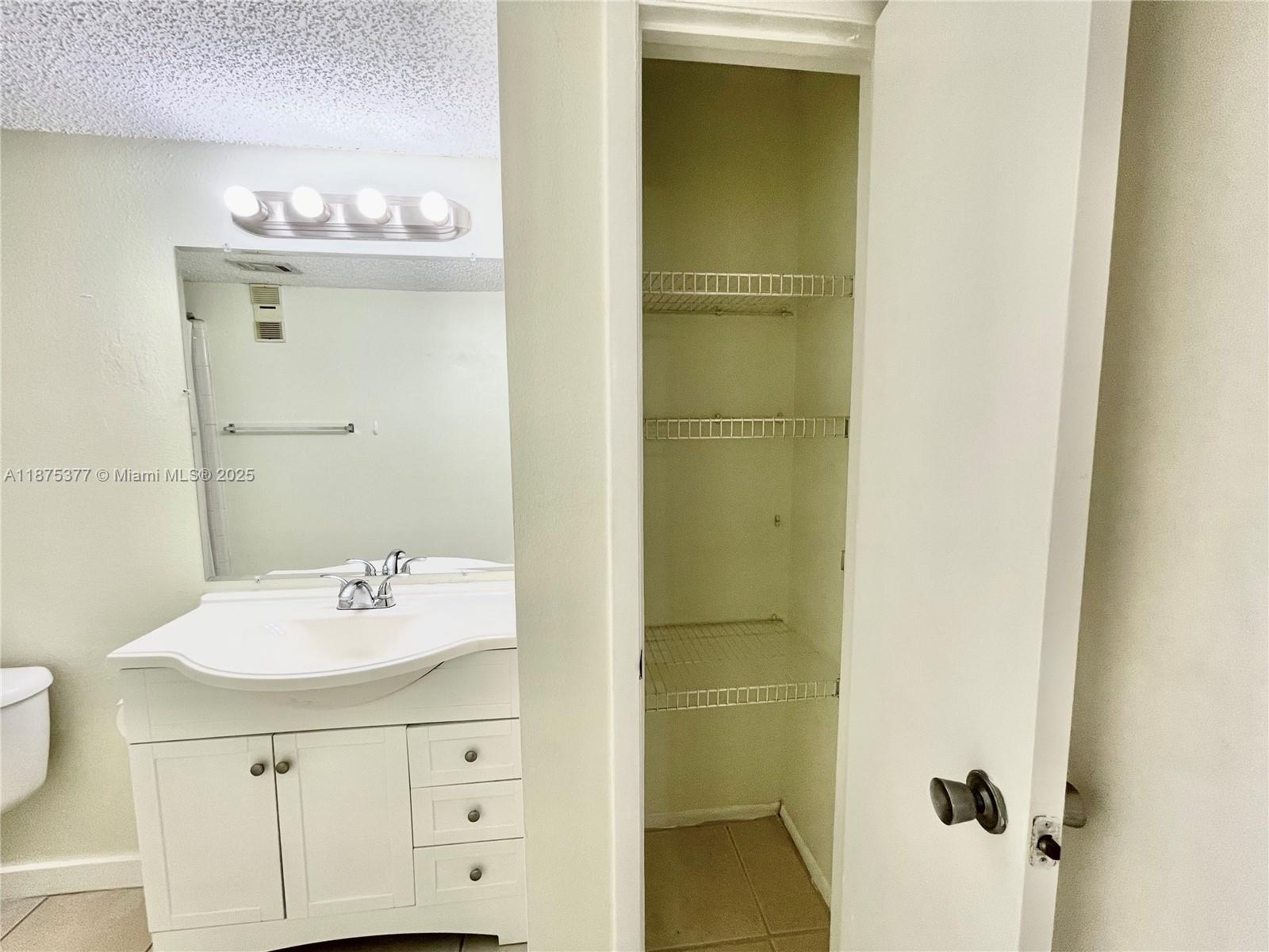 15591 Southwest 105th Terrace, Unit 527 Miami, FL 33196 - Photo 19 of 24 a bathroom with a sink mirror and vanity