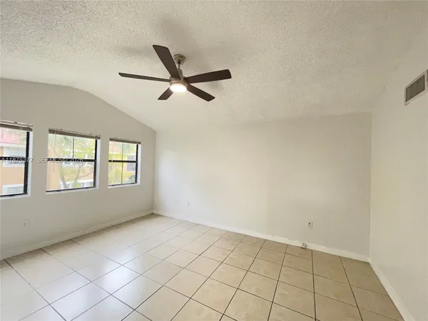 a view of trees and deck in the outdoor space