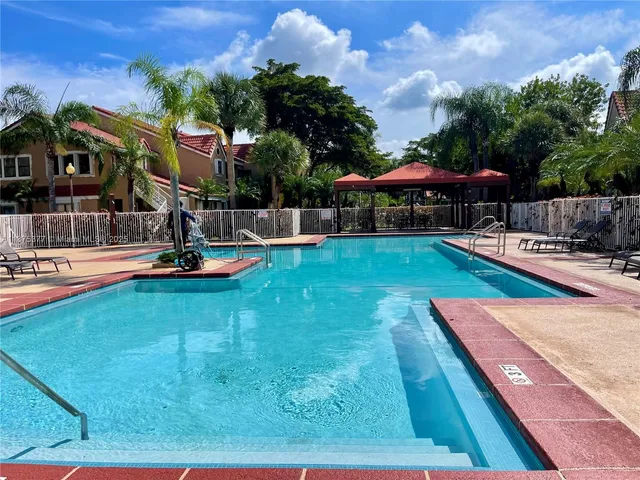 a view of a backyard with swimming pool