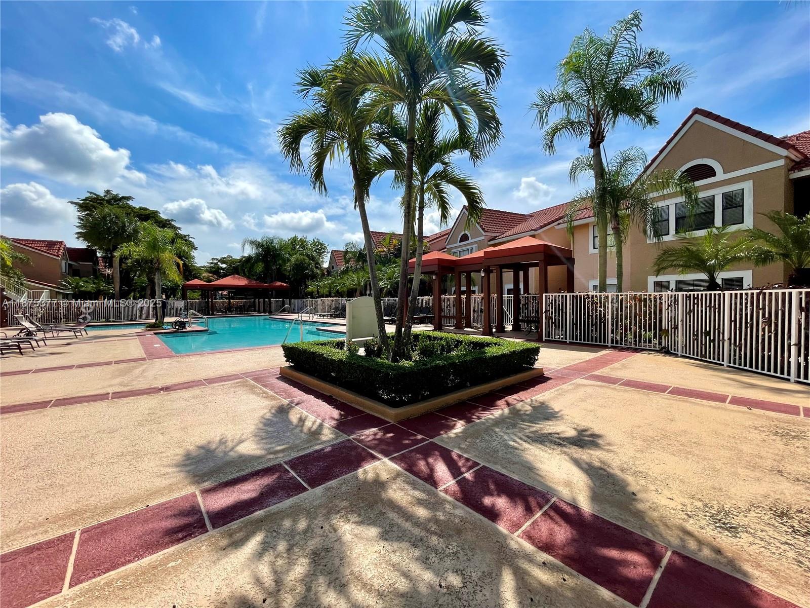 15591 Southwest 105th Terrace, Unit 527 Miami, FL 33196 - Photo 23 of 24 a front view of a house with garden