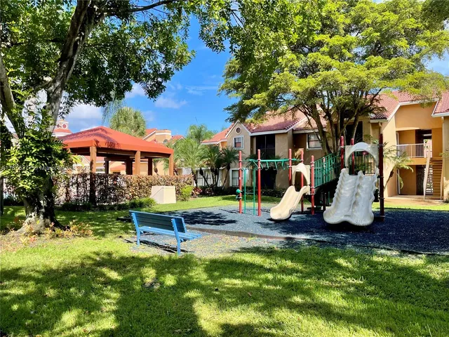 a view of a house with a yard patio and fire pit