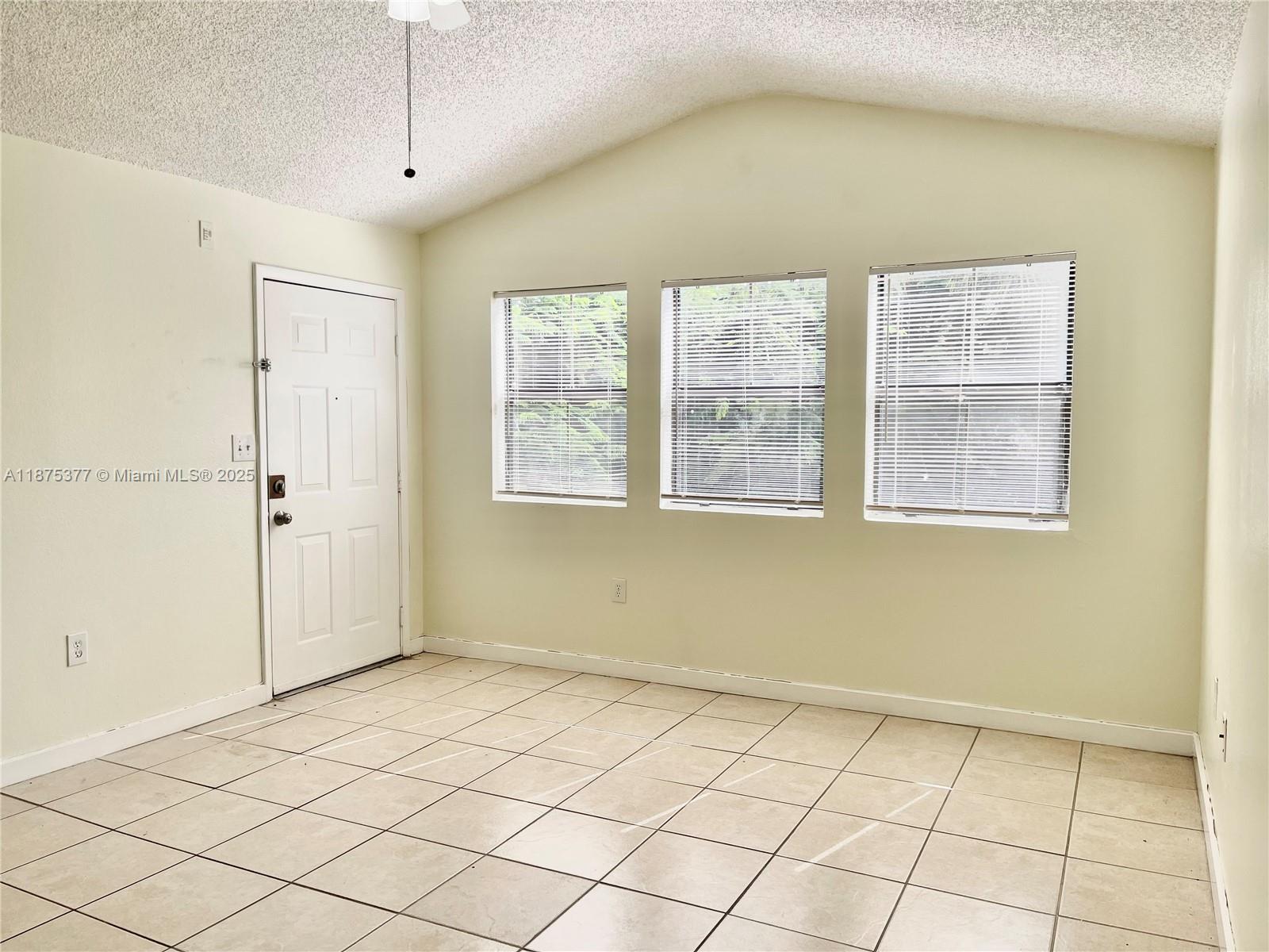 15591 Southwest 105th Terrace, Unit 527 Miami, FL 33196 - Photo 5 of 24 a view of an empty room with a window