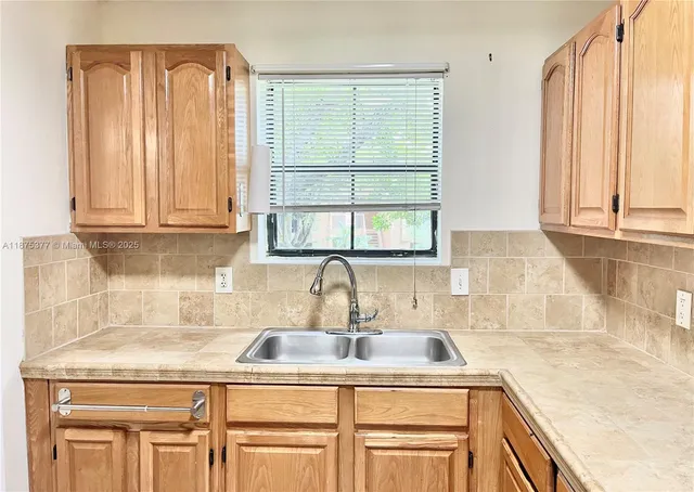 a kitchen with granite countertop a sink and a window
