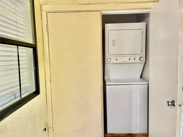 a kitchen with granite countertop stainless steel appliances a refrigerator and a sink