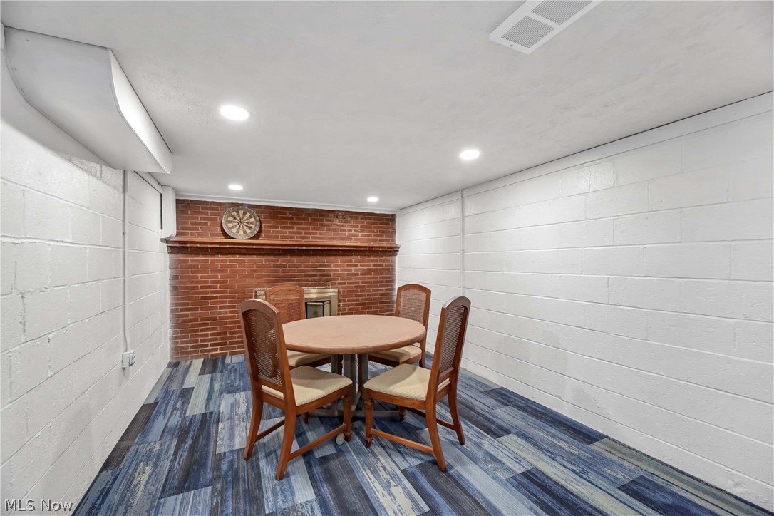 7528 State Road Parma, OH 44129 - Photo 27 of 40 Dining room with brick wall and dark wood-type flooring