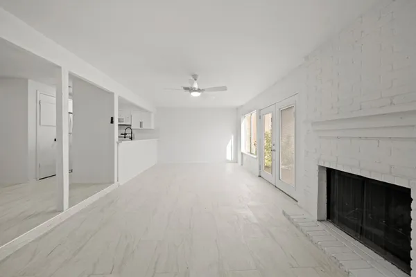 a kitchen with a sink a window and cabinets
