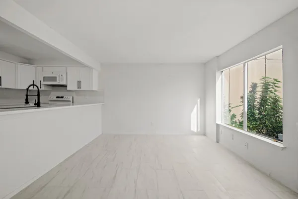 a view of an empty room with a fireplace