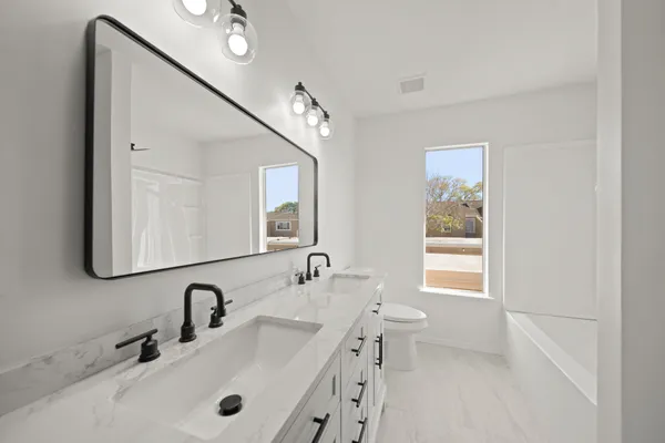 a bathroom with 2 sink and a mirror