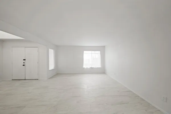 a view of an empty room and a window