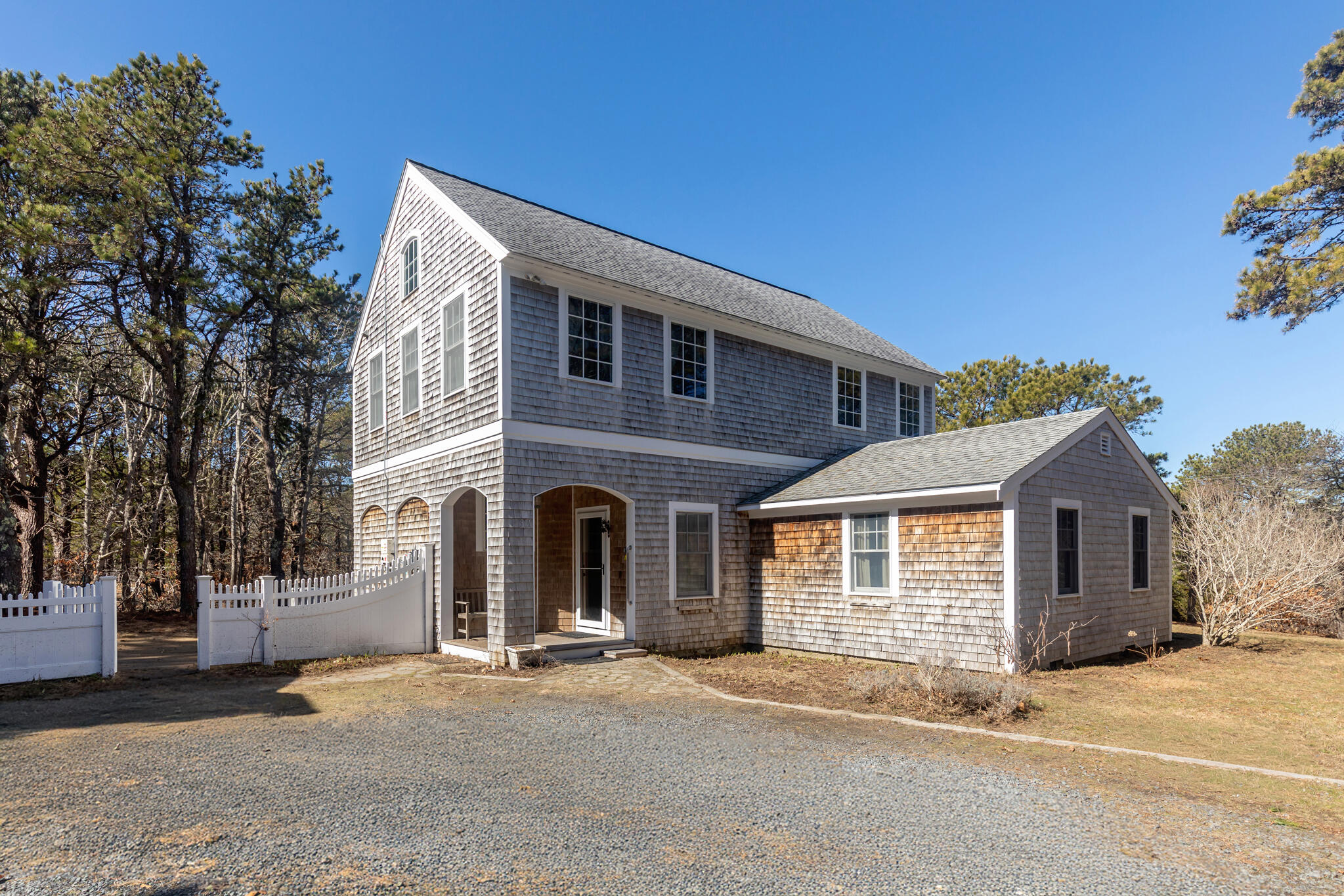 311 South Sunken Meadow Road Eastham, MA 02642 - Photo 3 of 57 a front view of a house with a garage
