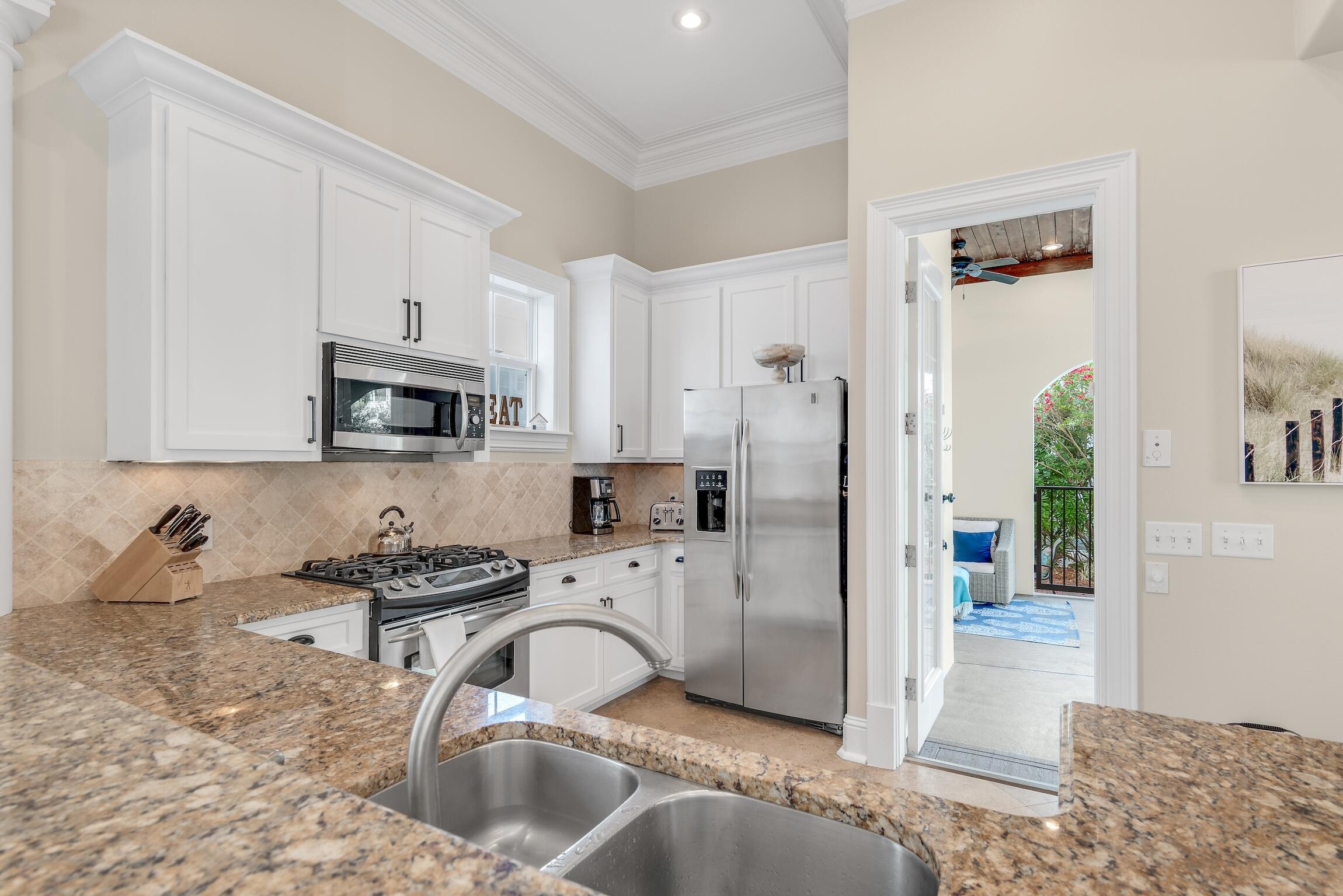130 Palmeira Way Santa Rosa Beach, FL 32459 - Photo 11 of 38 a kitchen with stainless steel appliances granite countertop a sink stove and refrigerator
