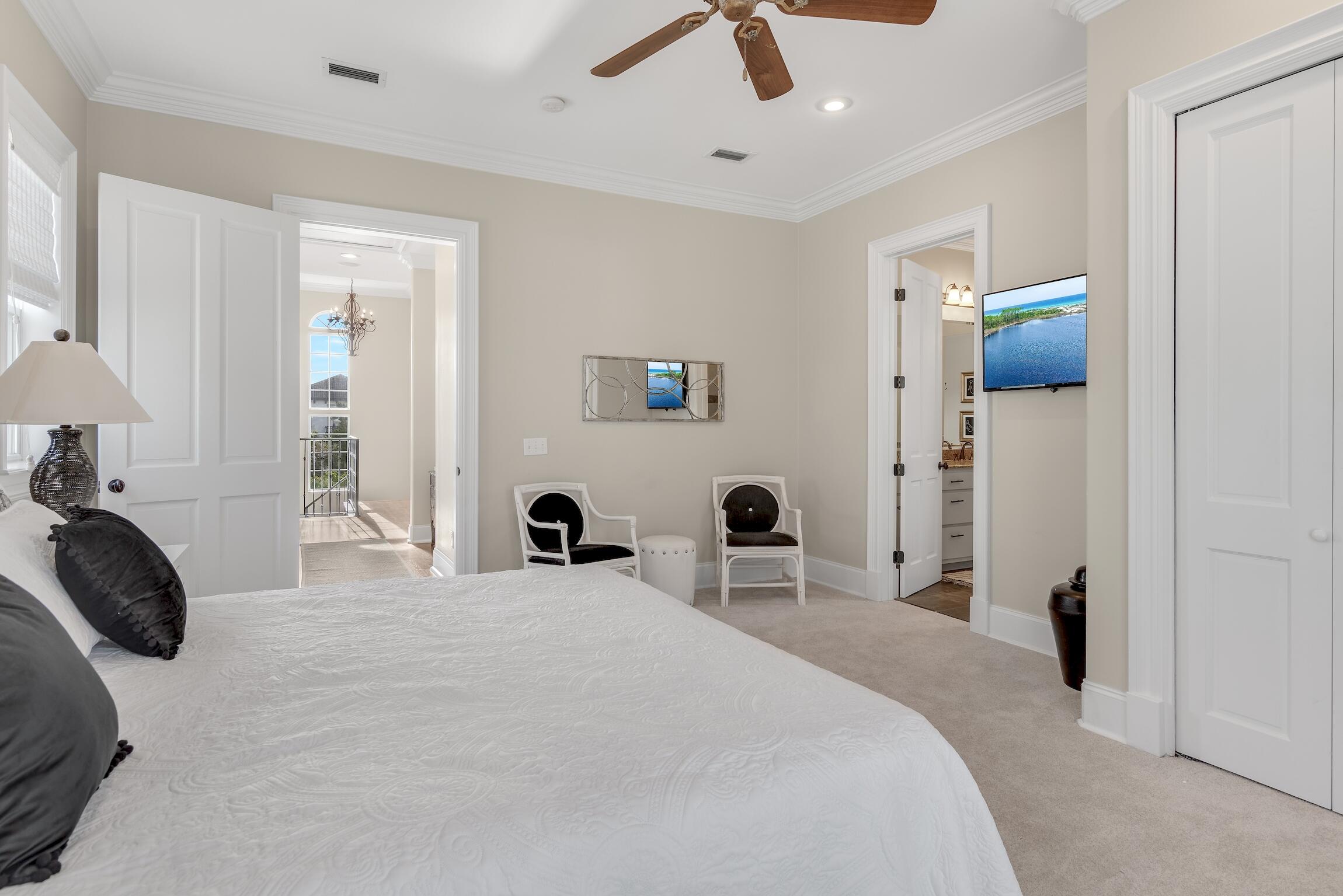 130 Palmeira Way Santa Rosa Beach, FL 32459 - Photo 15 of 38 a bedroom with a bed and a chandelier